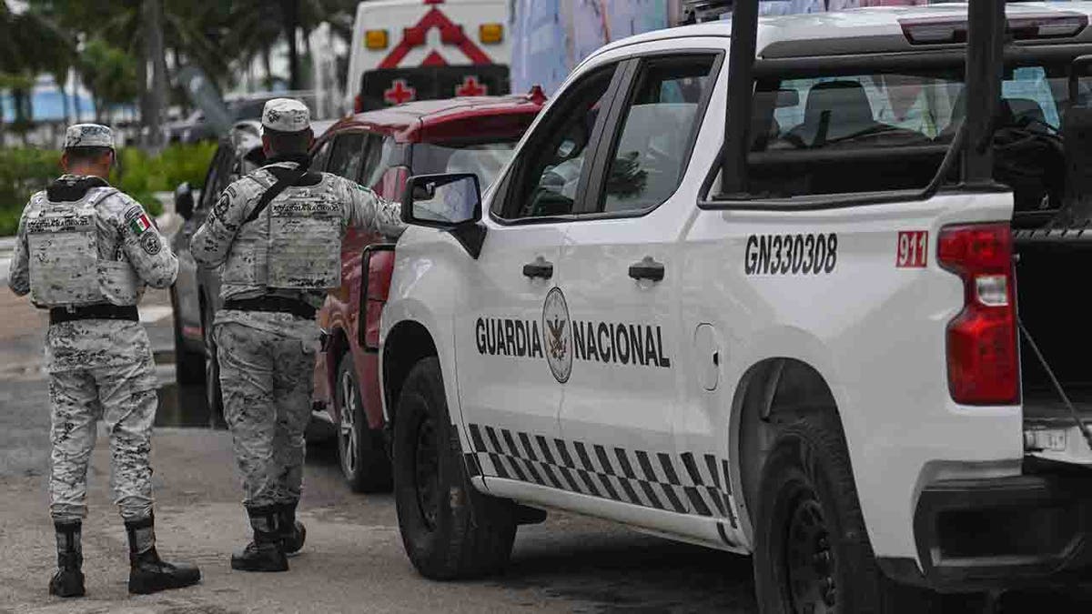 Guardia Nacional members near vehicle