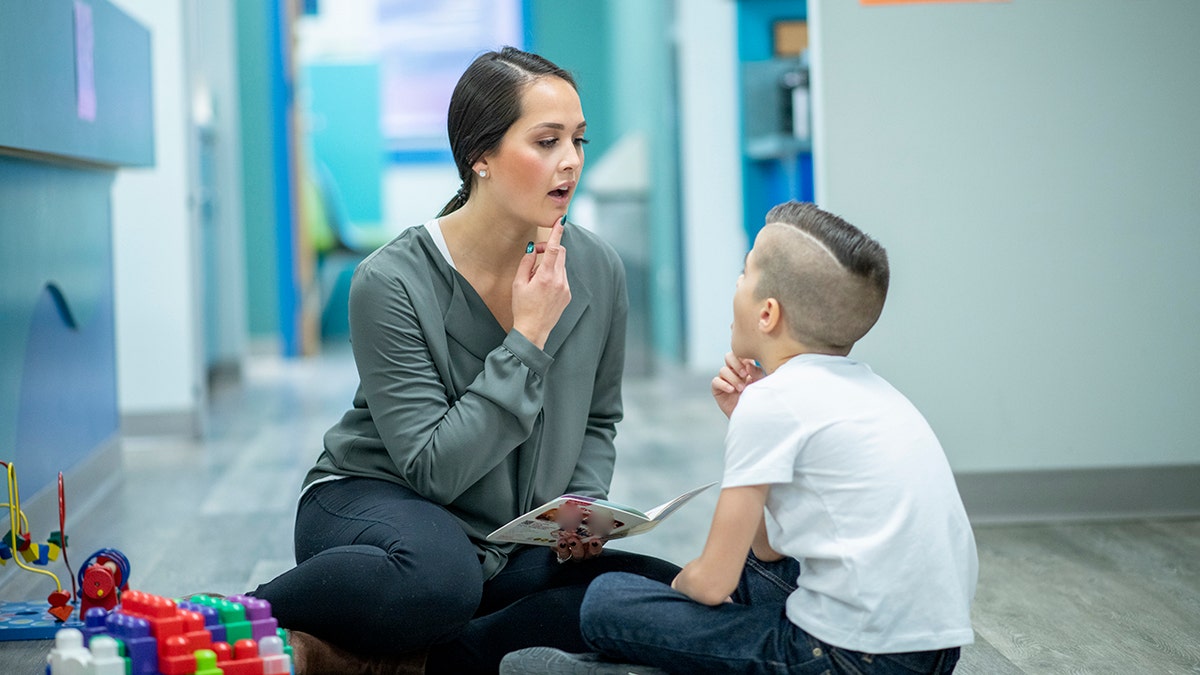 speech therapist works with kid