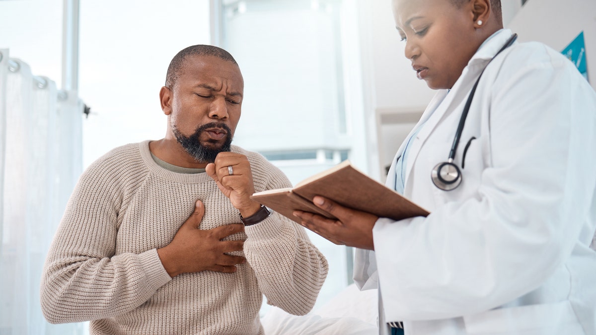 Man coughing at doctor