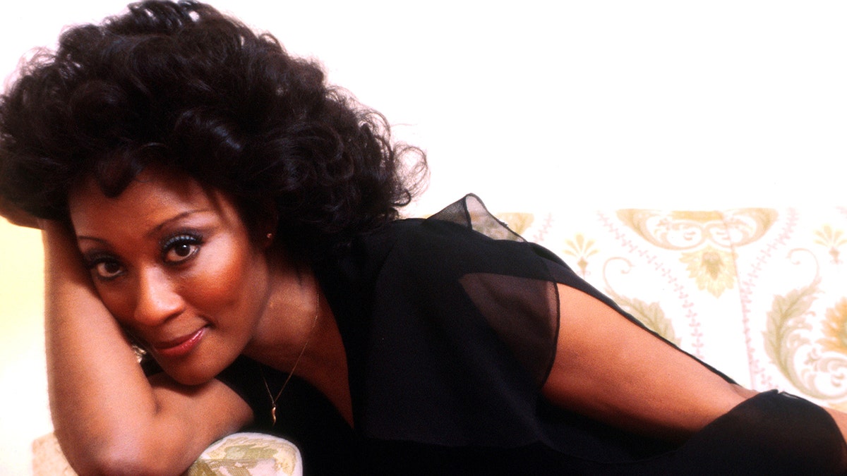 Marlena Shaw lies on her arm and soft smiles in a portrait