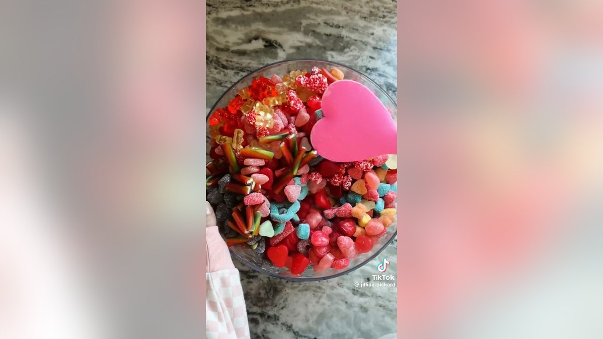 mixing candy salad with heart spatula