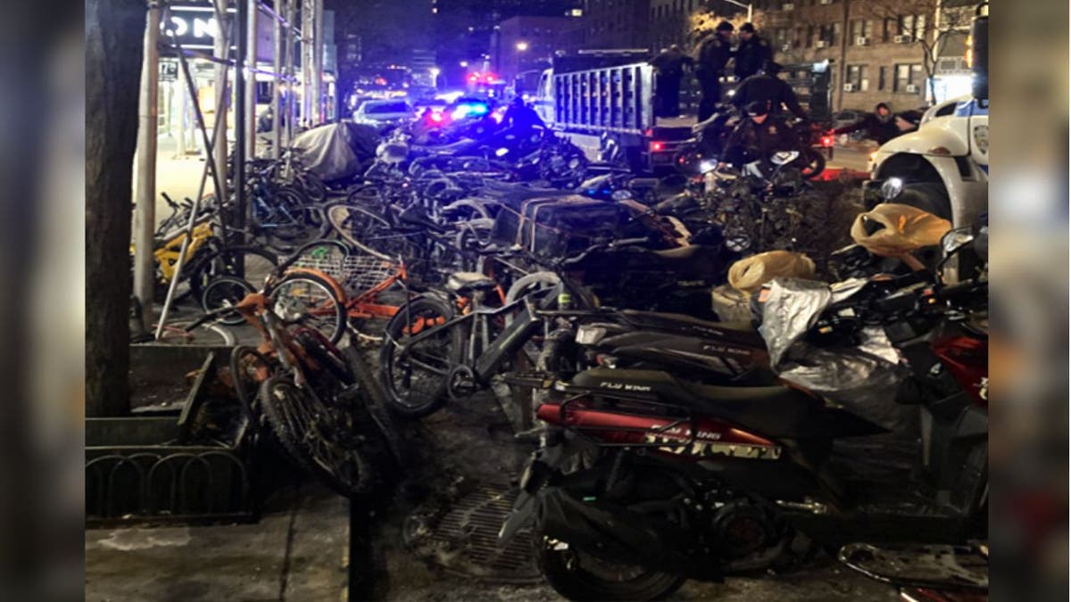 A night time shot of the NYPD confiscating mopeds 