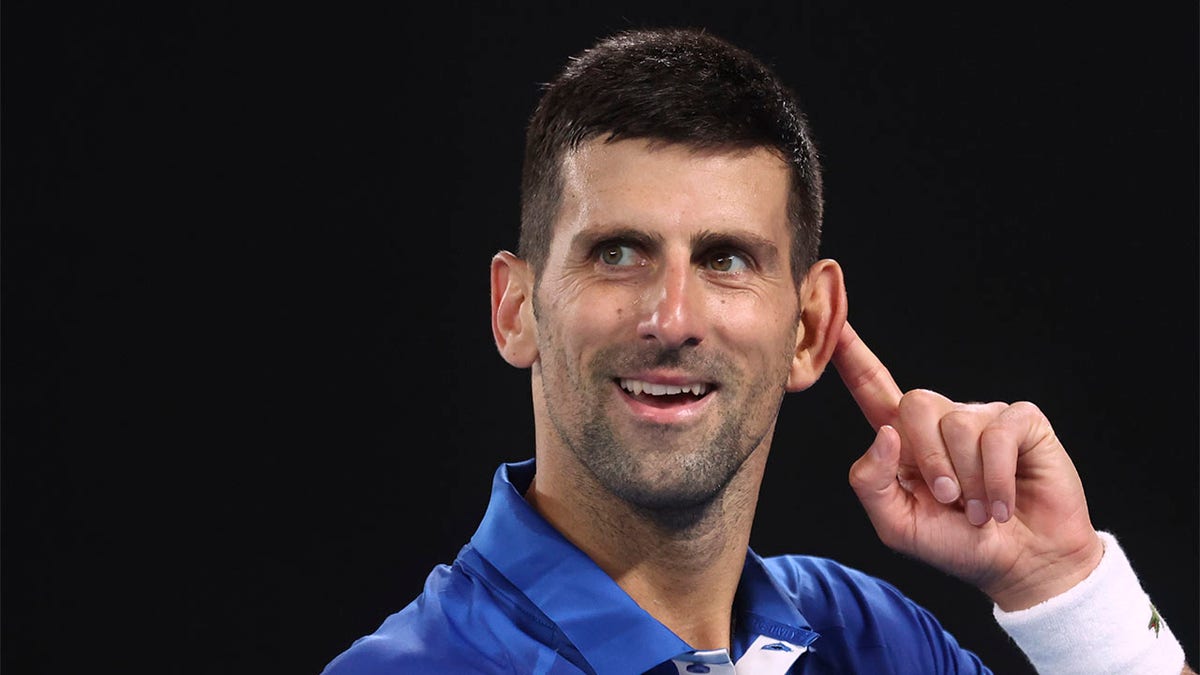 Novak Djokovic gestures to the crowd