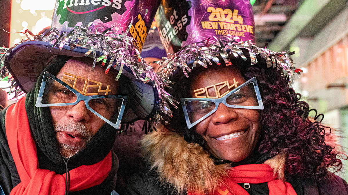 Revelers pose for a photo among the crowd in New York City