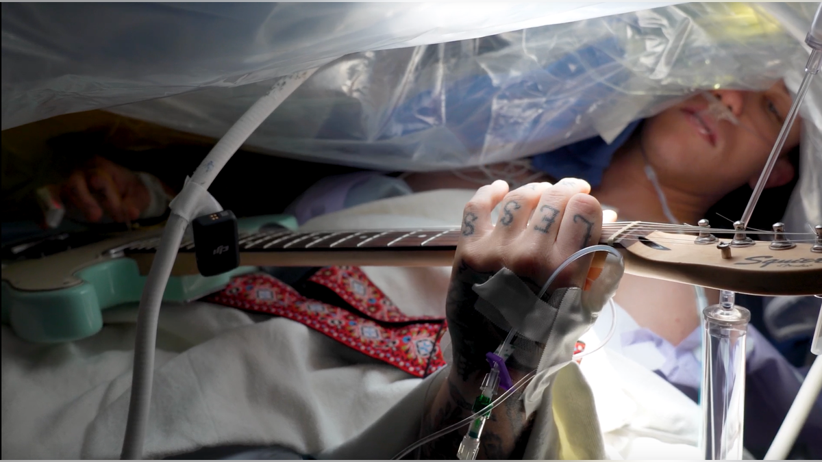 Patient playing guitar during surgery