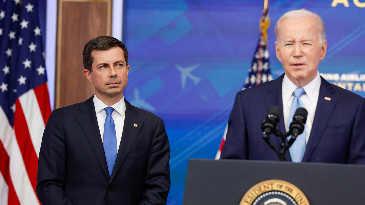 Secretary Pete Buttigieg, left, with President Biden