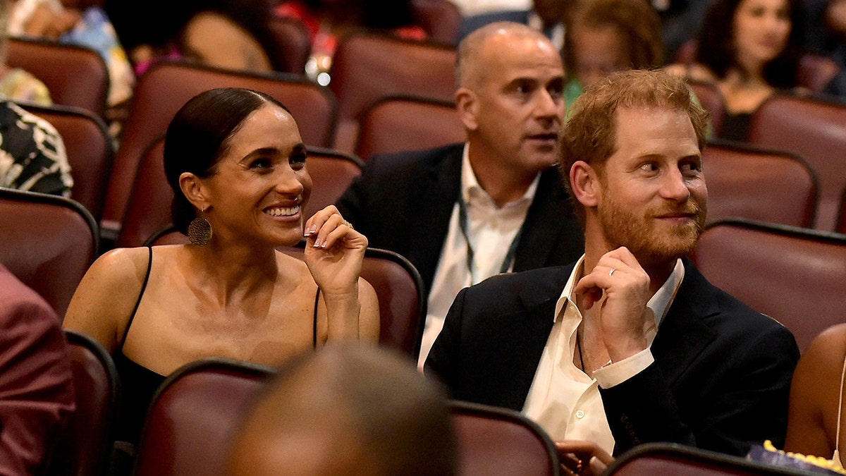 Prince Harry and Meghan Markle chuckle in movie theater in Jamaica
