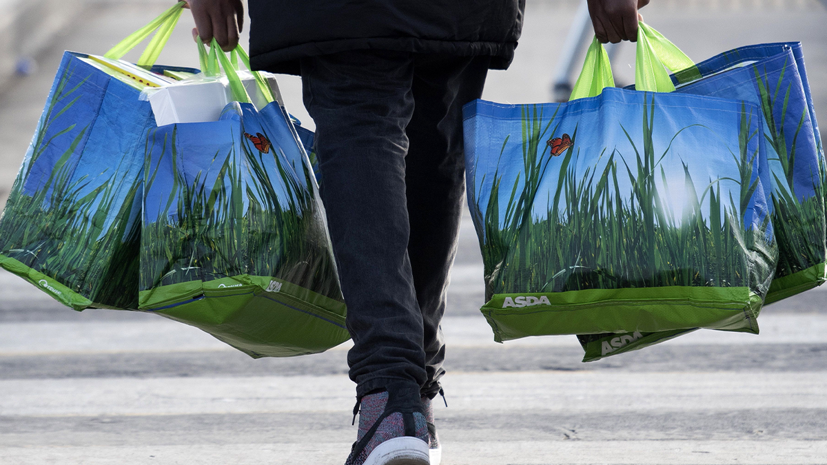 Shopper carrying reusable plastic bags