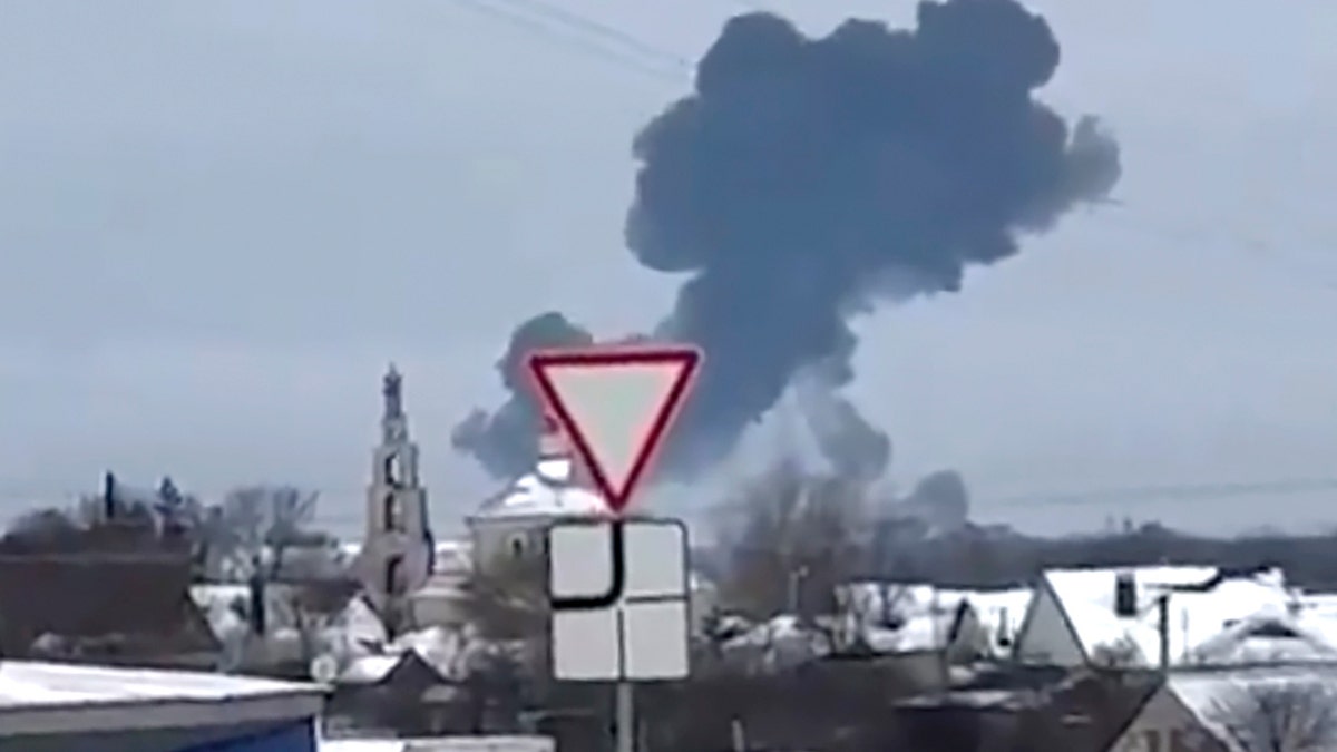 Smoke rises from the crash site of a Russian military transport plane