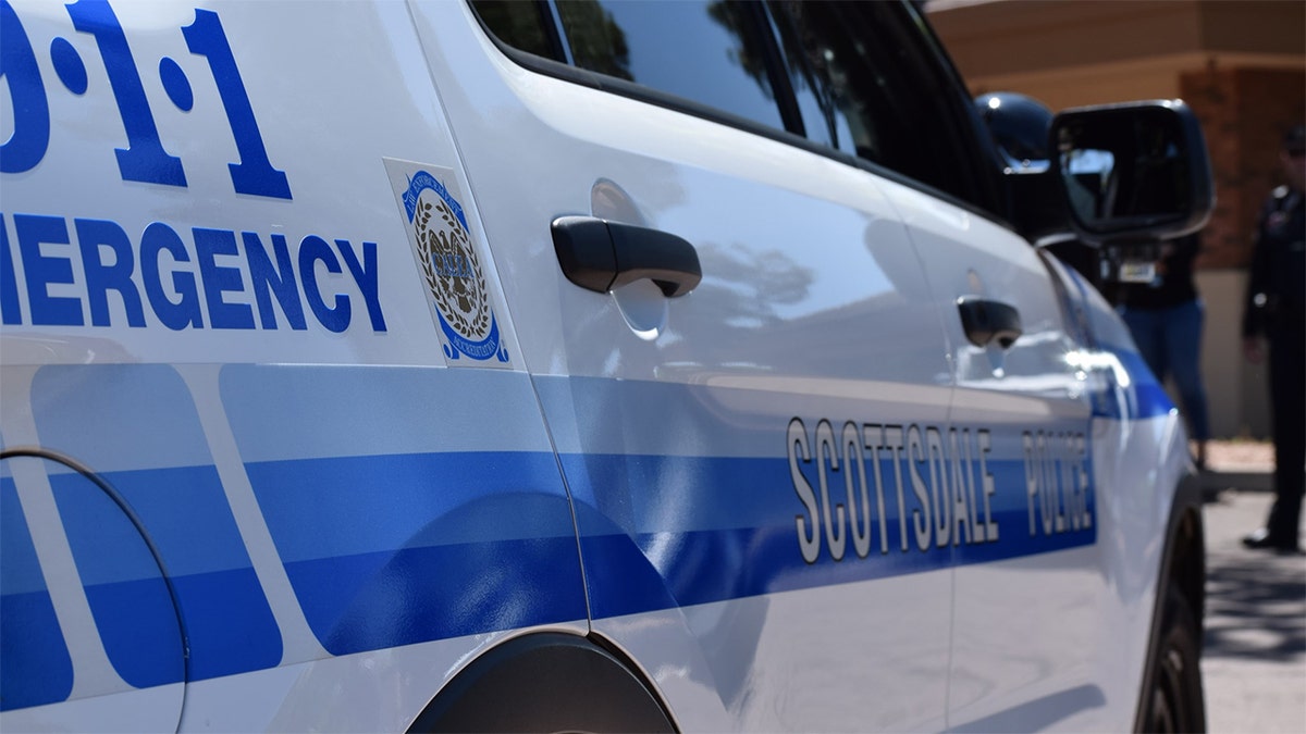 A white and blue car with a Scottsdale Police decal