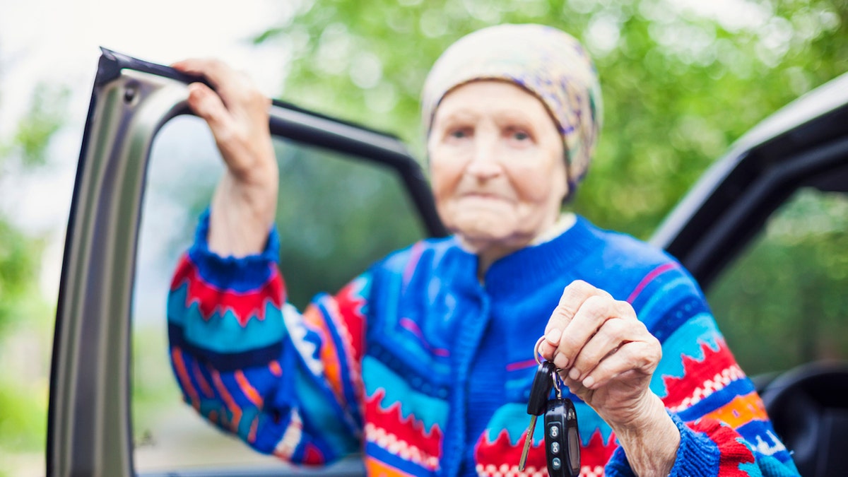 Elderly woman holding keys
