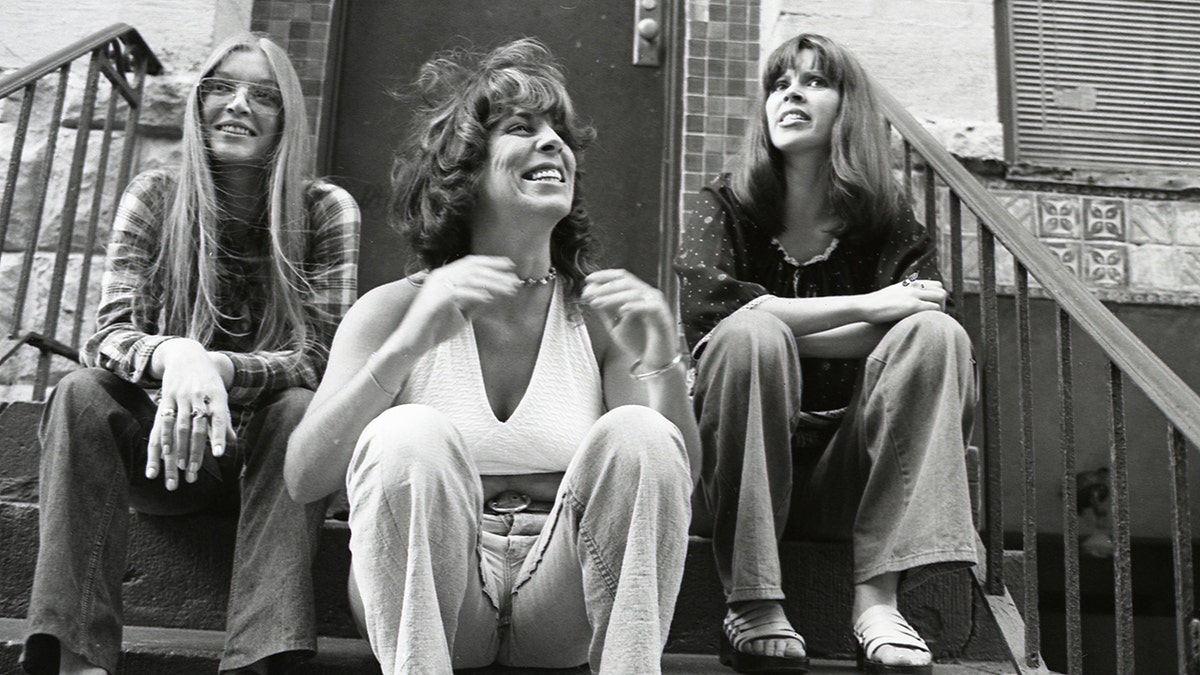 Mary Weiss sits on a stoop with the Shangri-Las