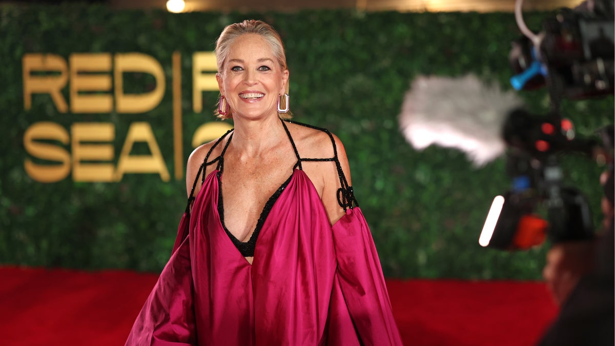 Sharon Stone in a hot magenta gown with open sleeves in Saudi Arabia