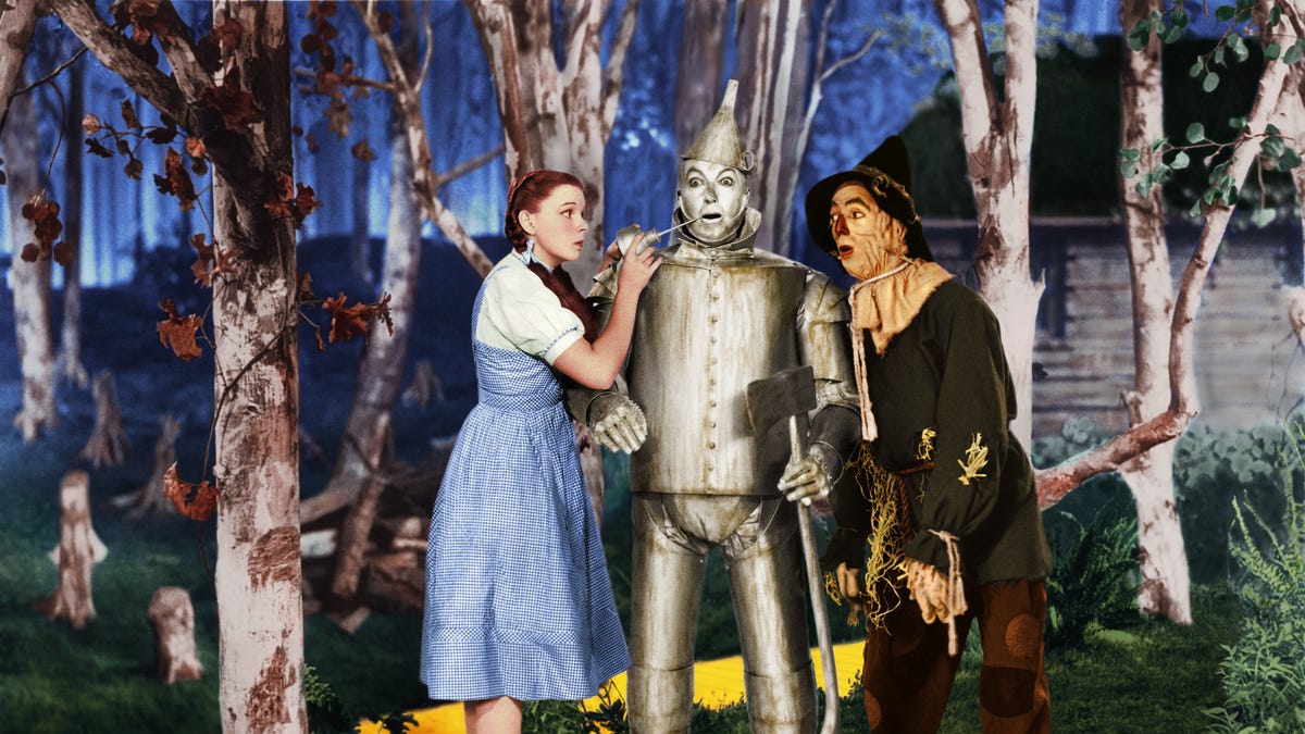 Judy Garland in "The Wizard of Oz," standing next to the Tin Man and Scarecrow