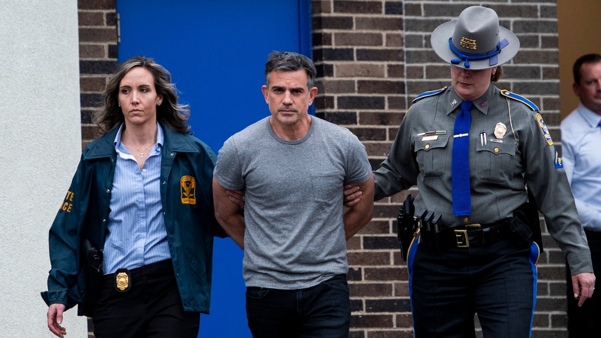 Fotis Dulos is escorted out of the Troop G State Police station before being placed in a cruiser Tuesday afternoon, Jan. 7, 2020. Dulos was arrested and charged with the murder of his estranged wife, Jennifer Farber Dulos, who has been missing since May. 