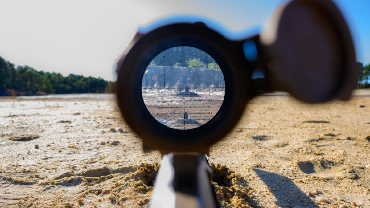 looking through sniper rifle scope downrange