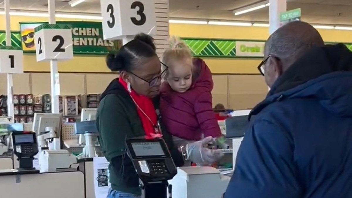 Supermarket cashier and toddler