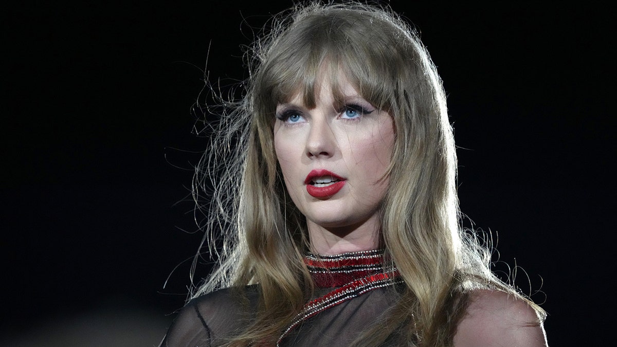 Taylor Swift looks up and serious during the Reputation portion of her Eras Tour set