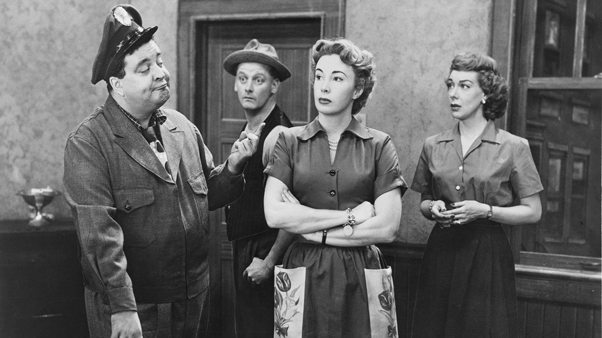 The cast of "The Honeymooners," Jackie Gleason, Art Carney, Audrey Meadows, and Joyce Randolph appear in a still from the show.