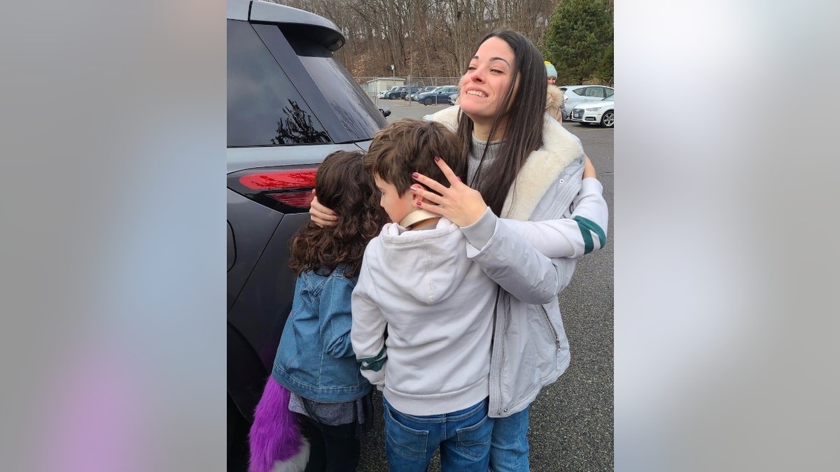 Nikki Addimando embraces her children after her release from prison