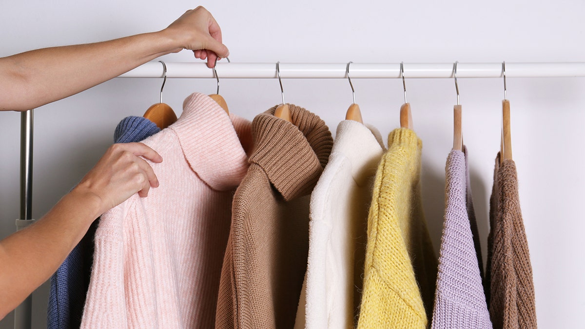 woman choosing sweater in the morning