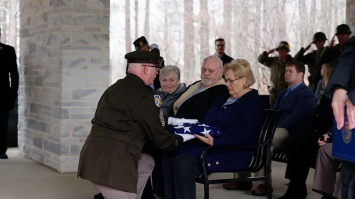 Cole's niece receiving American flag