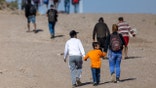 Immigrants from Venezuela walk towards a U.S. Border Patrol transit center after crossing the Rio Grande into the United States on January 08, 2024 in Eagle Pass, Texas. Immigrant crossings in the area have dipped dramatically since a major surge in the last months of 2023. (Photo by John Moore/Getty Images)