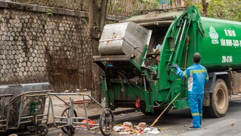 Woman survives being compacted into garbage truck after falling into dumpster