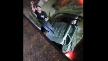 Texas driver rescued from floodwaters after standing on roof of vehicle, video shows