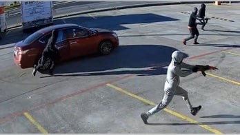 Dallas police hunt gunmen who unleashed hail of bullets in shopping center shooting caught on video