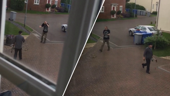 Neighbors caught on camera fighting each other with garden tools in quiet cul-de-sac