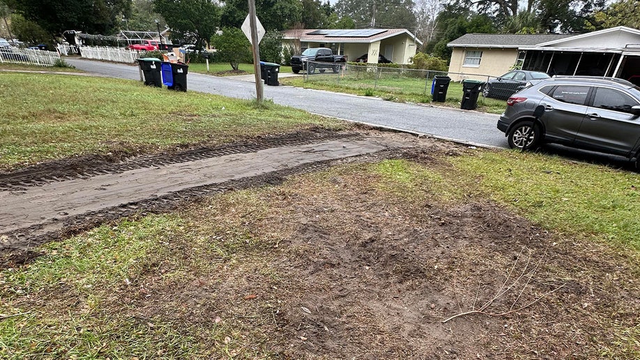 Mud and dirt track left across front lawn