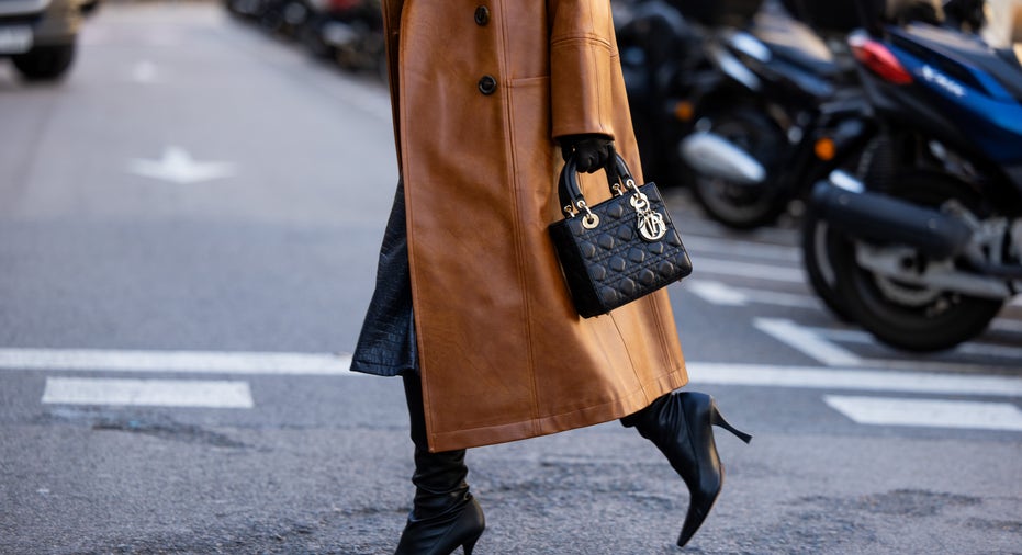 Woman wears leather jacket and bag