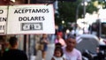 A sign outside a store reads in Spanish "We accept Dollars" in Buenos Aires, Argentina, December 12, 2023.