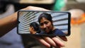 A family member shows a phone photo of Juana Guadalupe Recinos, who was detained last year during the government's crackdown on its war against drugs, in Santa Ana, El Salvador, Wednesday, Jan. 31, 2024. Police detained Recinos on a charge of &ldquo;illegal gathering&rdquo; as she walked to work leaving her two sons motherless for more than a year.