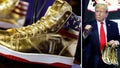 Republican presidential candidate and former President Donald Trump holds a pair of his new line of signature shoes after taking the stage at Sneaker Con at the Philadelphia Convention Center on February 17, 2024 in Philadelphia, Pennsylvania. Sneaker Con was founded in 2009 and is one of the oldest events celebrating sneakers, streetwear and urban culture. Trump addressed the event one day after a judge ordered the former president to pay $354 million in his New York civil fraud trial. (Photo by Chip Somodevilla/Getty Images)