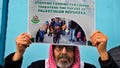 A Palestinian Hamas supporter holds a placard during a protest demanding that staff who were fired in the Gaza Strip over allegations that they took part in the Oct. 7, attack on southern Israel be returned to their jobs and that countries resume funding of the agency, in front of the United Nations Relief and Works Agency (UNRWA) headquarters in Beirut, Lebanon, on Tuesday, Jan. 30.