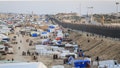 Displaced Palestinians reside alongside the Egyptian border wall.