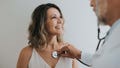 Doctor listening to patient's heart with stethoscope