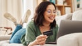 Relax, laptop and credit card, happy woman on couch in living room for internet banking in home for online shopping. Ecommerce payment, smile and cashback, girl on sofa with computer and website sale - Fox News