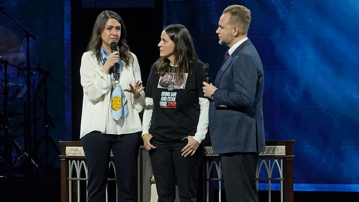 Two women and a man in a suit