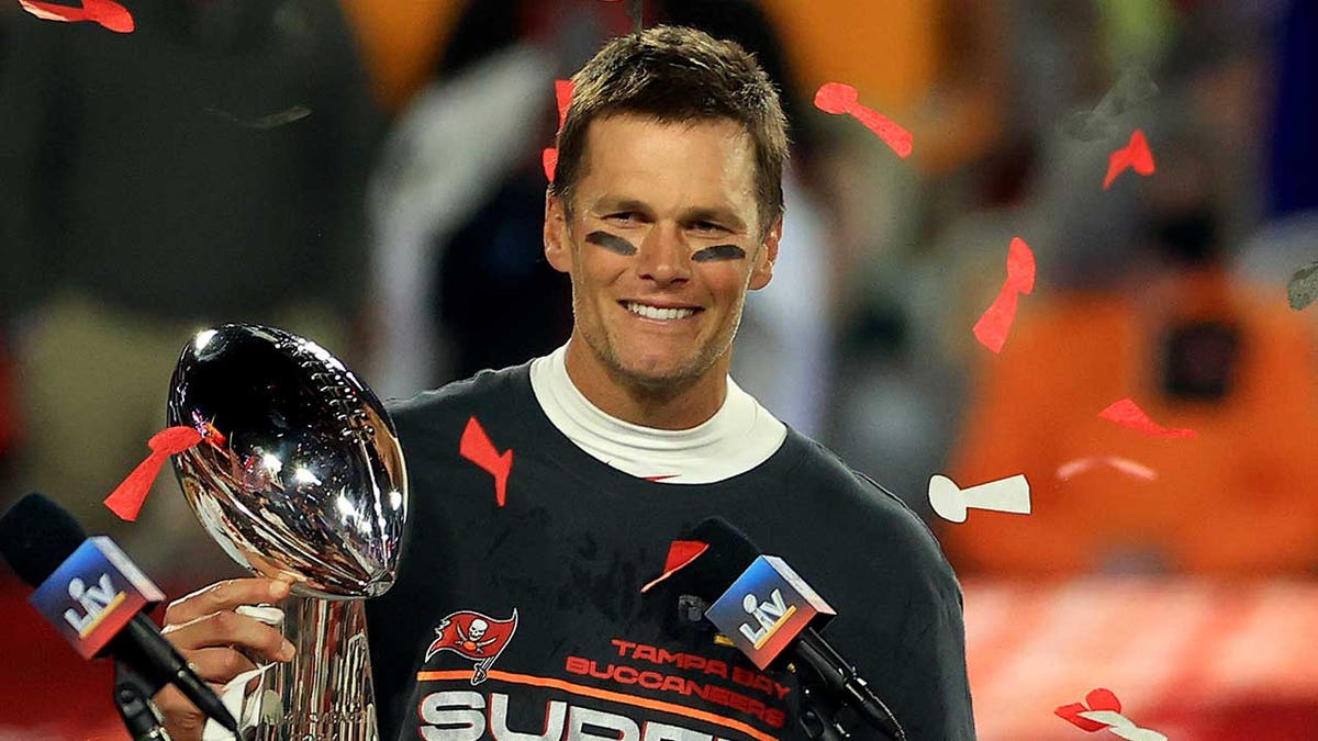 Tom Brady hoists the trophy