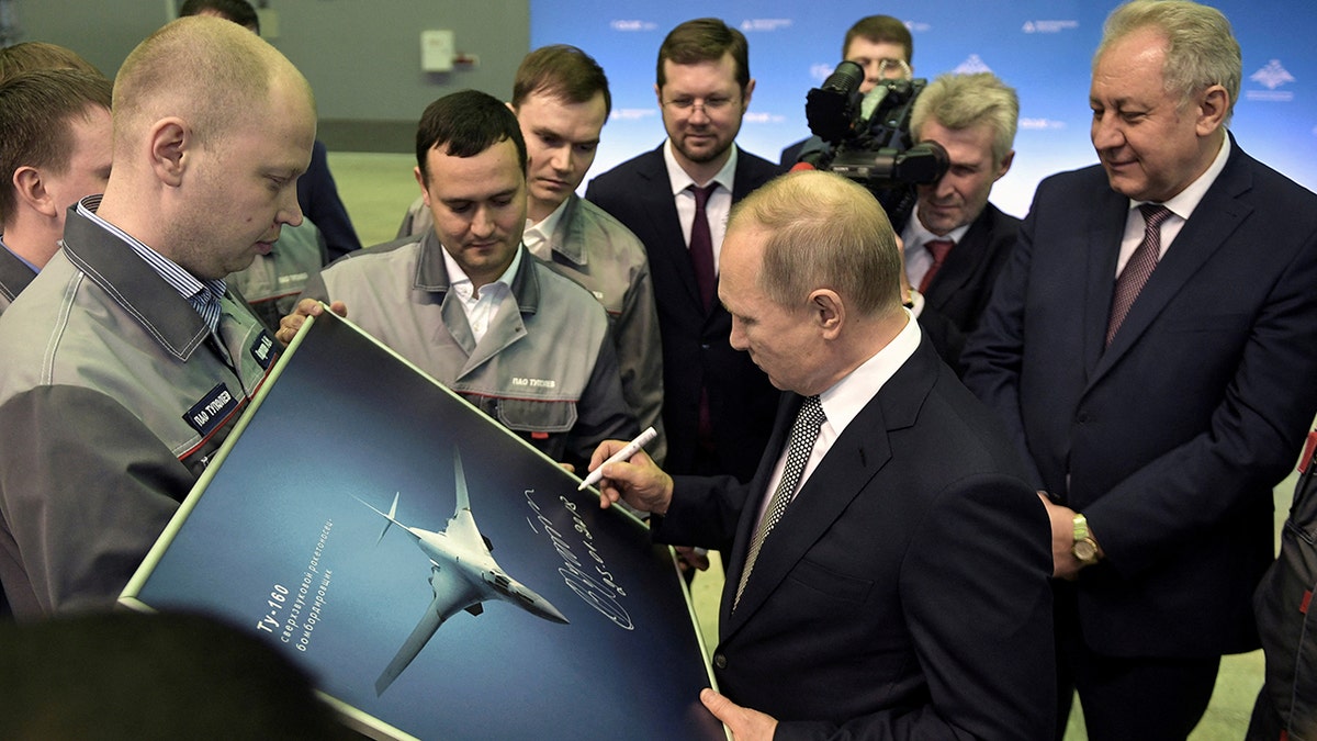 Putin signing a photo