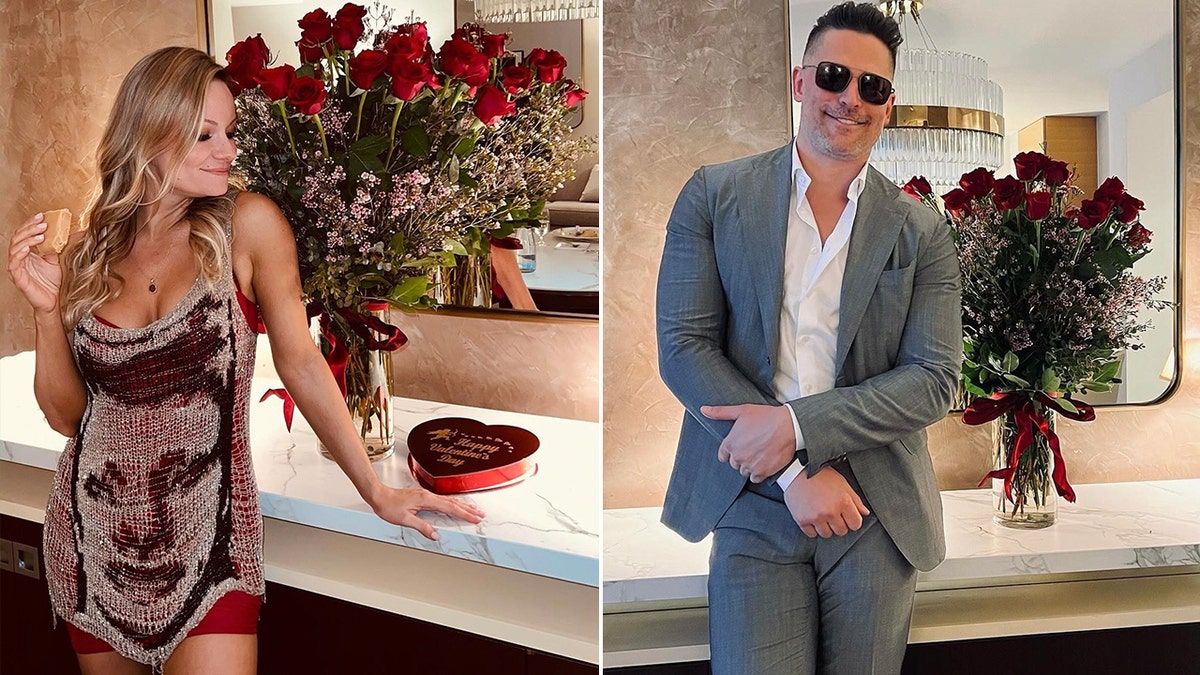 Caitlin O'Connor in a red slip and chained dress with a face on it smiles in front of a bouquet of roses split Joe Manganiello in a grey suit stands in front of the same flowers