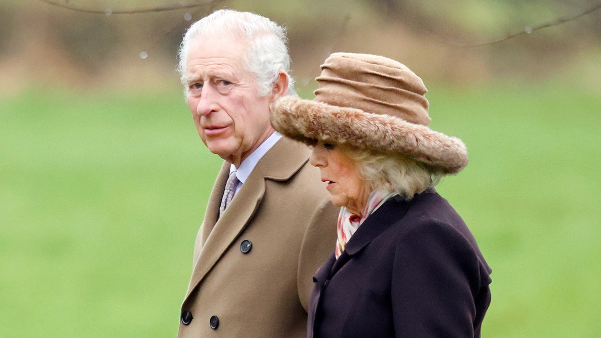 King Charles walking with Queen Camilla outdoors