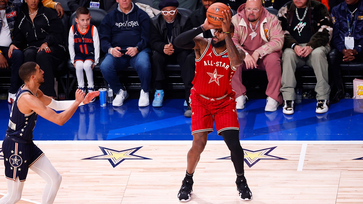 LeBron James shoots three-pointer