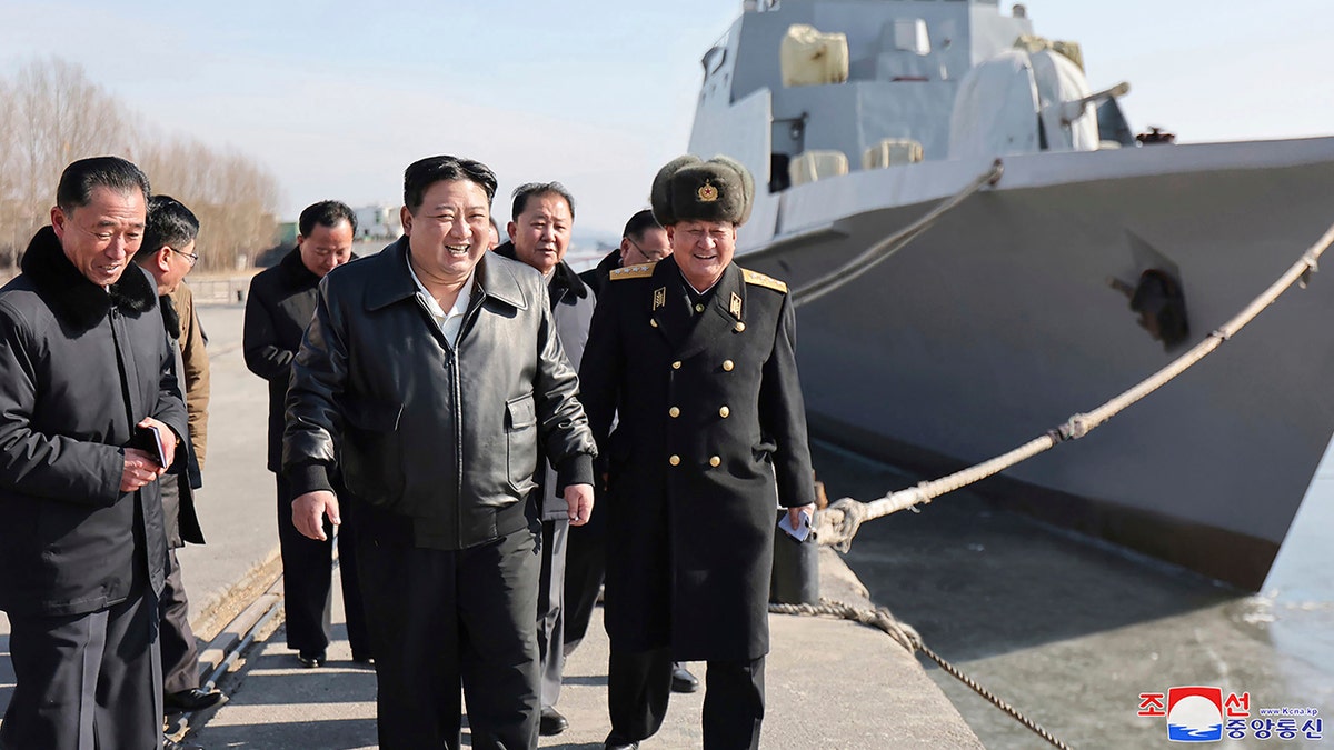 Kim next to a ship