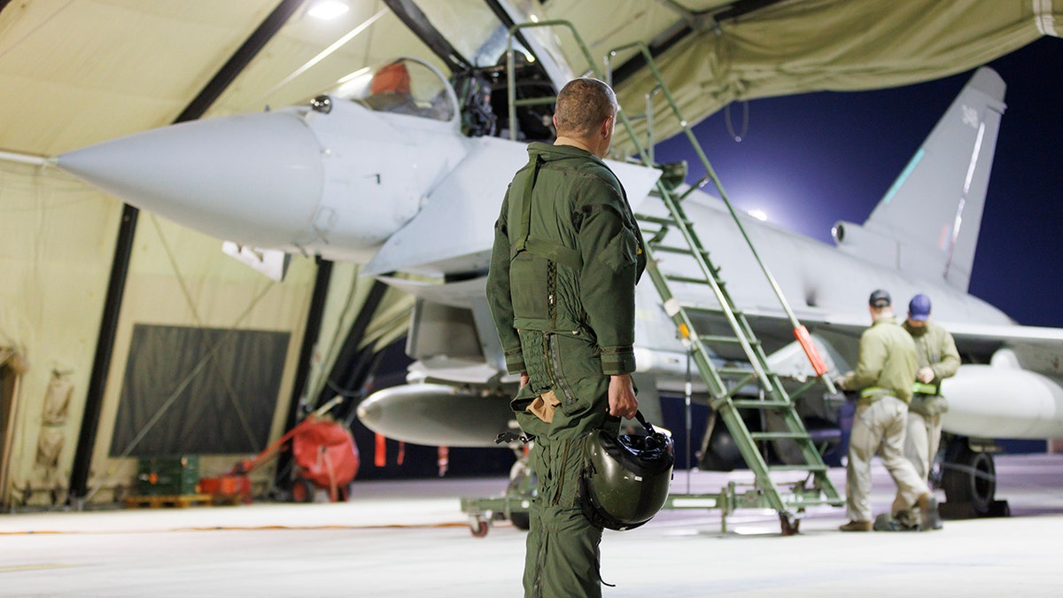 Soldier standing next to a plane