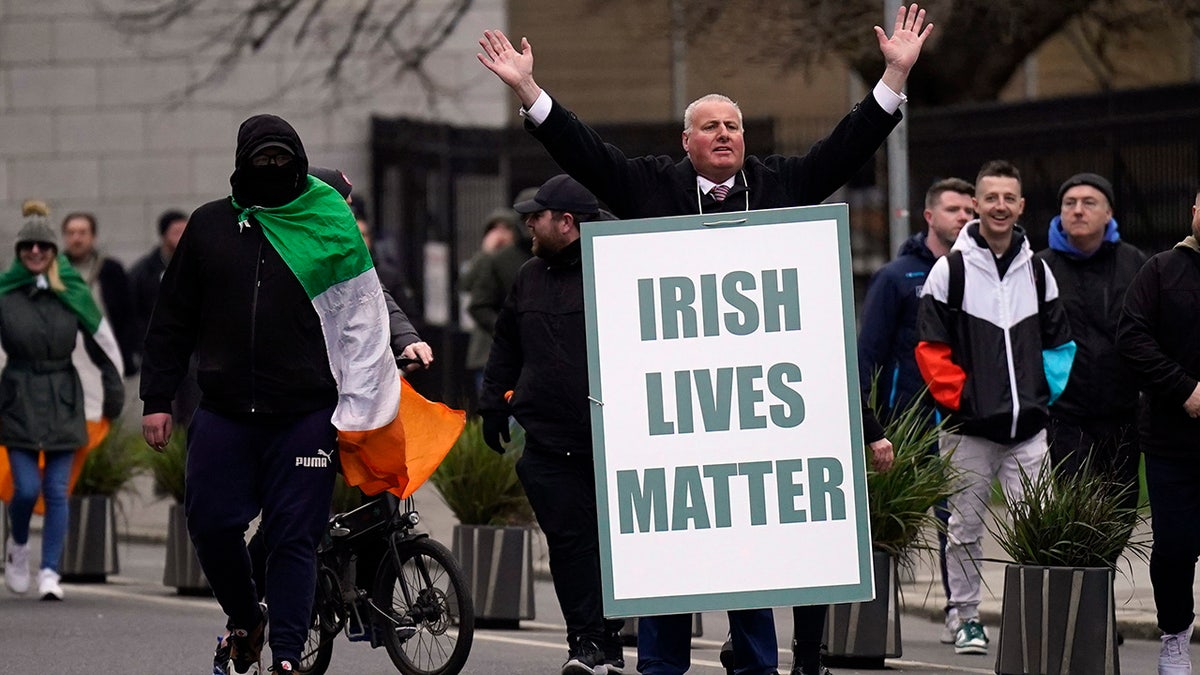 Dublin protester holds Irish Lives Matter poster