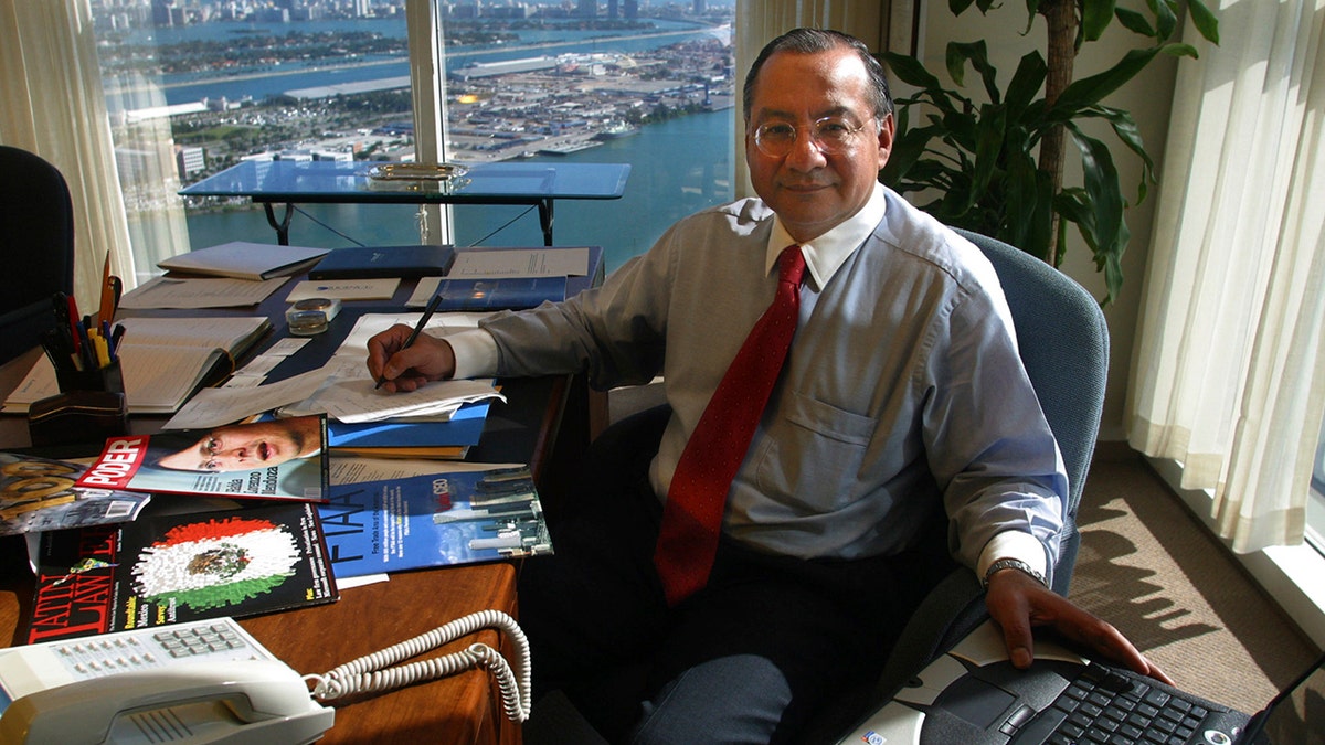 Victor Manuel Rocha sitting astatine a desk